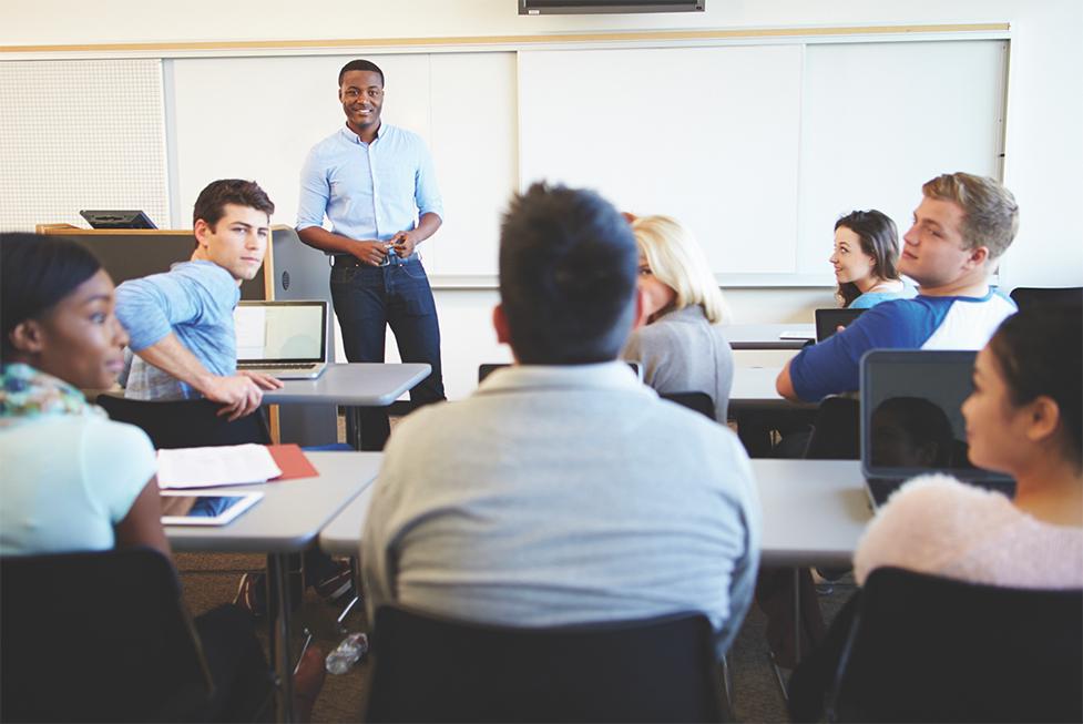 a teacher speaking to a classroom full of students