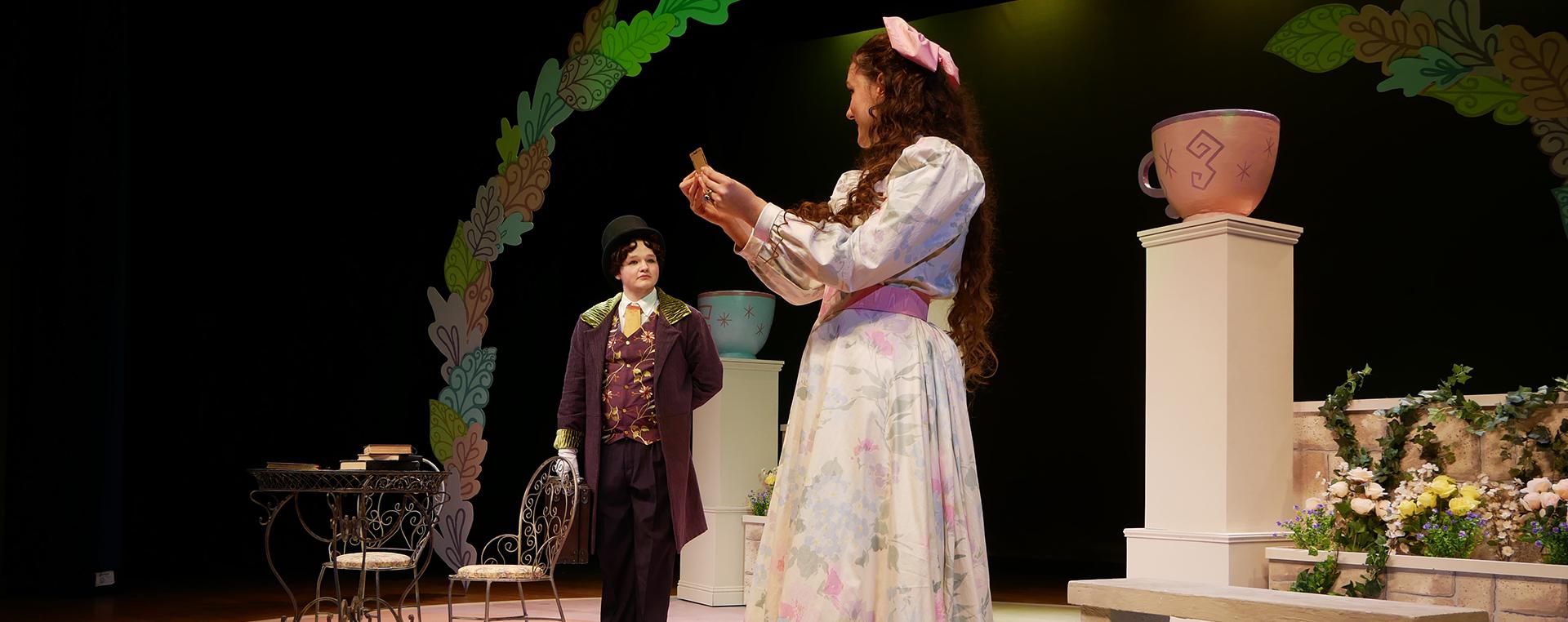 two actresses on stage in 19th century clothing