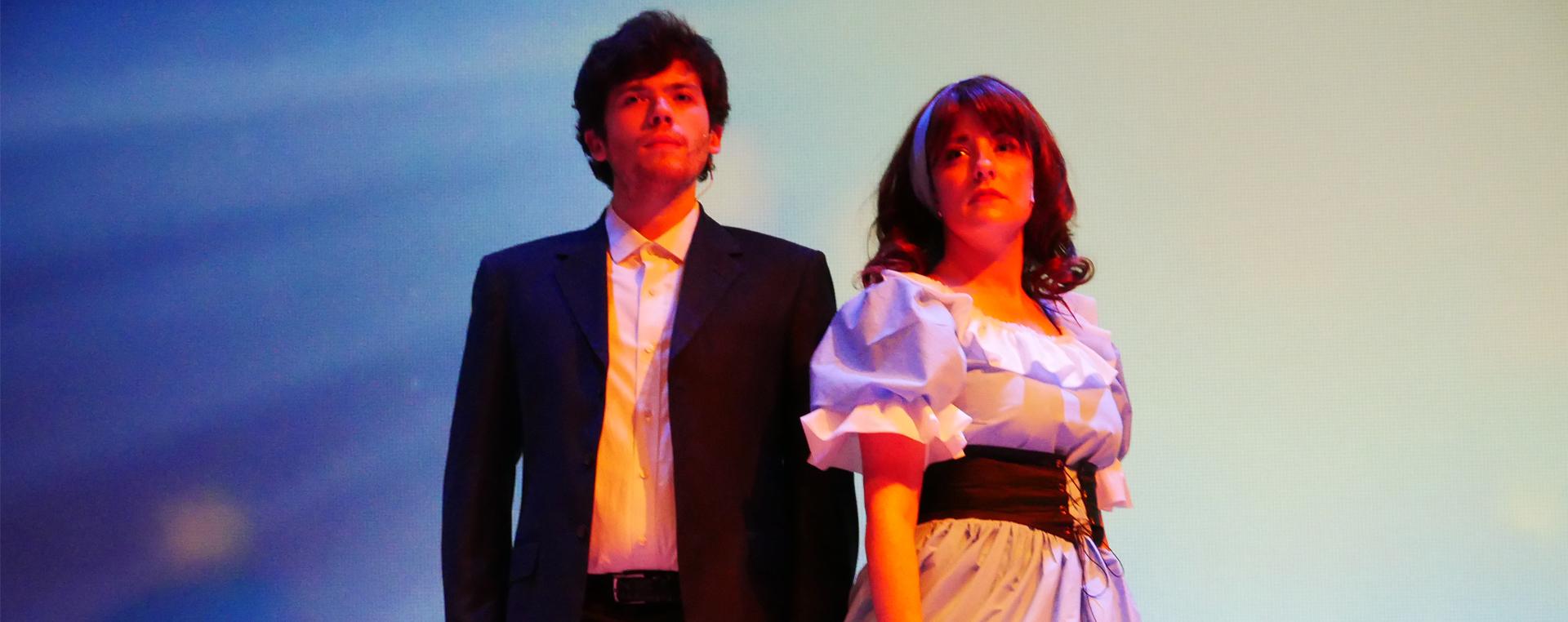 guy and girl lit by stage lighting