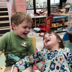 Honors program staff member Amanda Bennett's two children laugh in the child development center