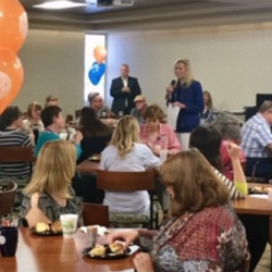 This group photo shows President Ashford speaking to a large group of employees donors during the annual Break of Champions on campus.