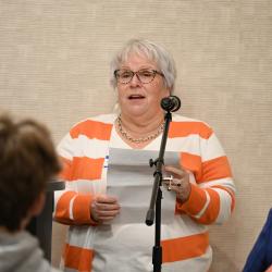 Sharon Butler speaks into a microphone. Sharon Butler speaks into a microphone.
