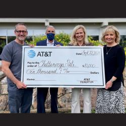 4 people holding poster size check