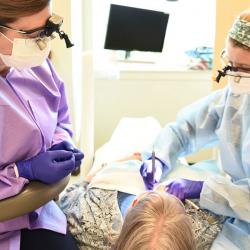 faculty members supervising dental hygiene student