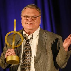 man holding an award