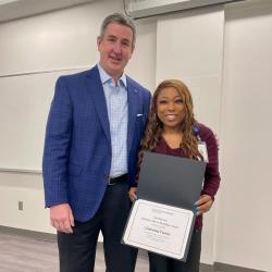 man presenting a certificate to woman