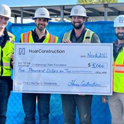 4 men holding a giant size check