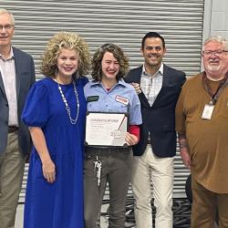 student with award and group of people