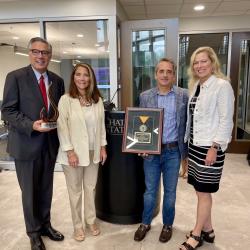 Greg Vital, Dr. Kim McCormick, Brad Cobb, and Dr. Rebecca Ashford stand side by side holding philanthropy awards. Greg Vital, Dr. Kim McCormick, Brad Cobb, and Dr. Rebecca Ashford stand side by side holding philanthropy awards.