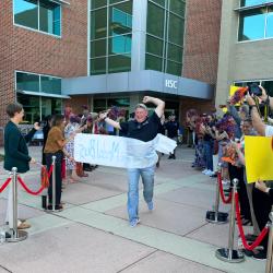 A SkillsUSA competitor from ChattState runs through a banner before boarding a bus to SkillsUSA nationals in Atlanta. A SkillsUSA competitor from ChattState runs through a banner before boarding a bus to SkillsUSA nationals in Atlanta.