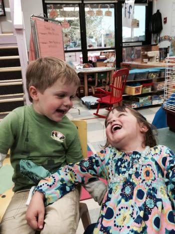 Honors program staff member Amanda Bennett's two children laugh in the child development center