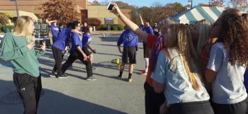 Photo of a group of students holding poses for a Mannequin Challenge