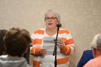 Sharon Butler speaks into a microphone.