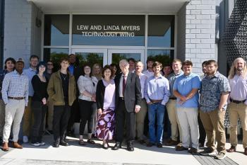 Lew and Linda Myers surrounded by students at the opening of the Myers Technology Wing