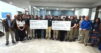 TVA Westinghouse Donation 2026 A group of well-dressed students, faculty, and business leaders hold two oversized checks from TVA and Westinghouse.
