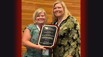 2 women holding award