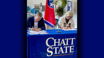 a man and woman signing an agreement