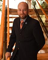 Bo Drake poses in front of stairwell of the CBIH building.